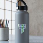 Breathe deeply holographic sticker with minimalistic typography stuck on a gray water bottle, mockup